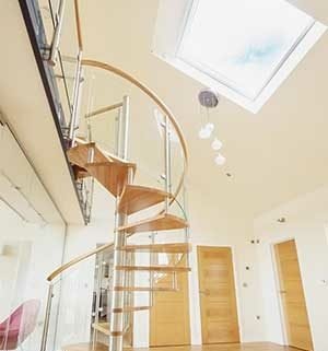 oak step spiral with curved glass. Large roof window above