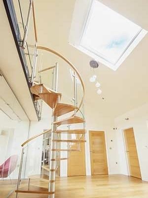 oak step spiral with curved glass. Large roof window above