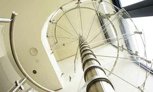 view looking up through acrylic steps of a spiral staircase