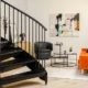 lovely black spiral stair with wall behind with painting - modern style