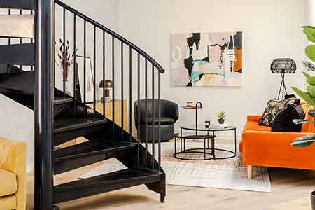 lovely black spiral stair with wall behind with painting - modern style