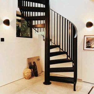 custom black steel spiral staircase with pictures on rear wall