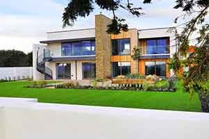 large house. Rear picture showing garden and dark spiral stair