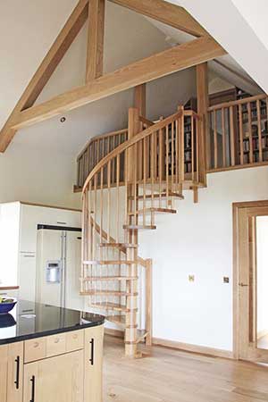 all oak spiral stair with oak beams above