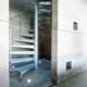 internal silver spiral stair in steel with blank walls around