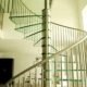 large spiral staircase with stainless steel and glass in a living space