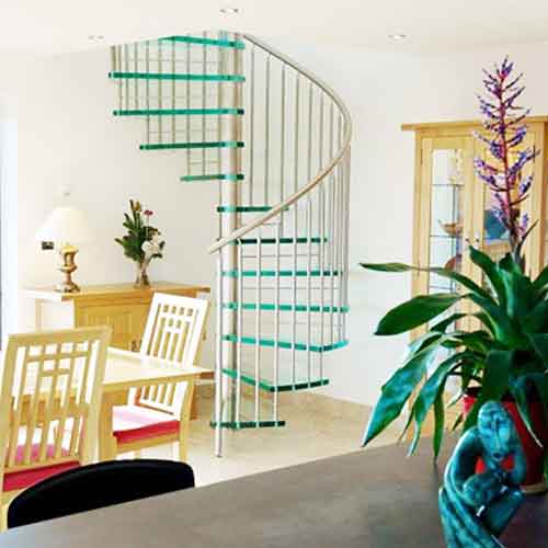 living area with table and flower arrangement with glass spiral staircase