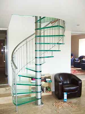 sitting room with sofa and chairs and a glass spiral stair