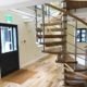 open looking oak and stainless spiral stair in an office setting
