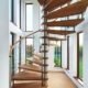 stunning spiral stair in a house with windows behind