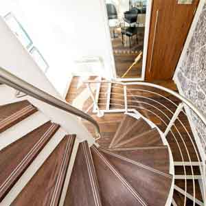 view looking down on a wood and white steel spiral stair