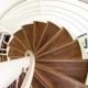 view floating above a walnut spiral stair with steel handrail
