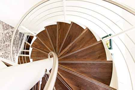 view floating above a walnut spiral stair with steel handrail