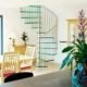 kitchen diner with table and chairs with a glass spiral staircase