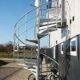 rear of commercial building with spiral stair and bike