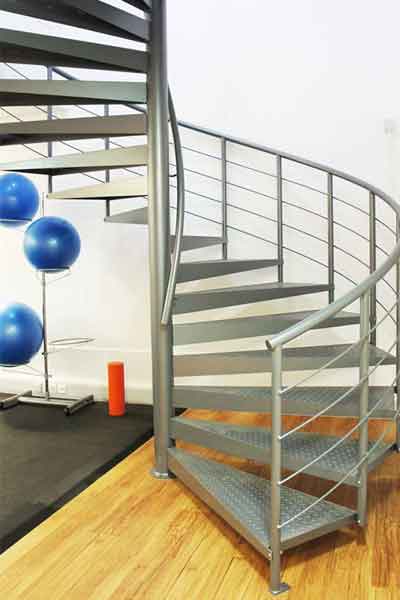 blue metal spiral staircase with blue exercise balls behind