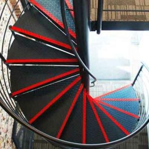 plan view of a black steel spiral stair with red strips to front of step