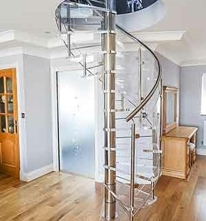 A living space with a timber floor and an acrylci spiral stair