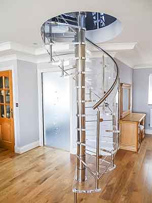 A living space with a timber floor and an acrylci spiral stair