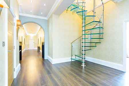 huge hallway with glass spiral staircase with glass steps