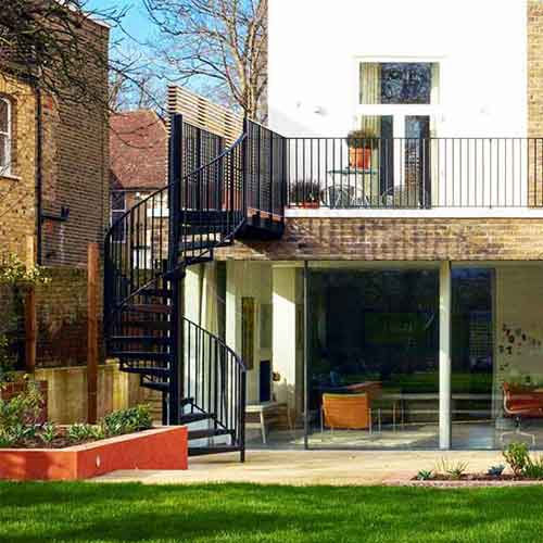 garden with black spiral stair and green grass