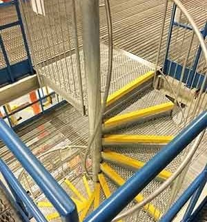 industrial setting with spiral staircase and steel floors