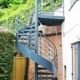 domestic setting courtyard with a grey spiral staircase