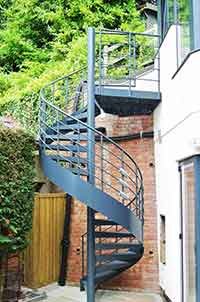 domestic setting courtyard with a grey spiral staircase