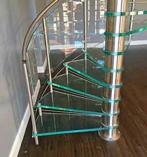 timber floor with glass spiral staircase steps above