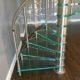 timber floor with glass spiral staircase steps above