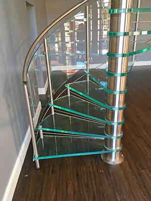 timber floor with glass spiral staircase steps above