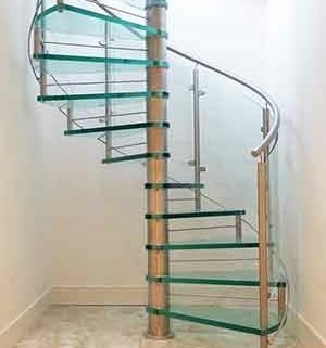 white walls on three sides and a glass spiral stair in the middle