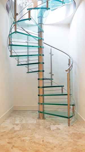 white walls on three sides and a glass spiral stair in the middle