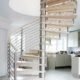 spiral stair in light wood with kitchen on show behind and a window