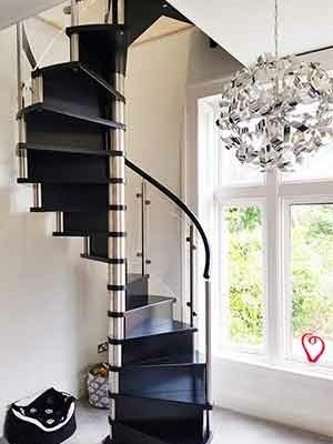 tight black wooden spiral stair with large window