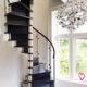 tight black wooden spiral stair with large window