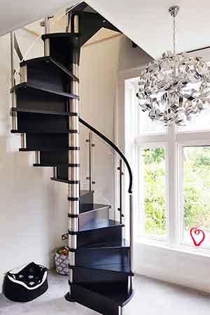 tight black wooden spiral stair with large window