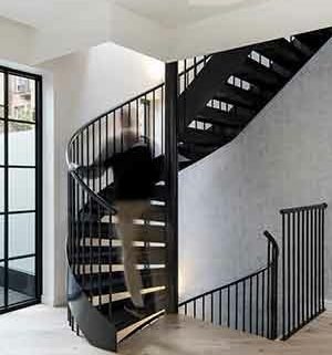 black spiral stair with man walking up