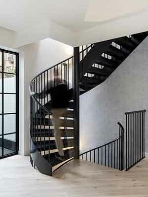 black spiral stair with man walking up