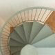view from above of a light green spiral staircase