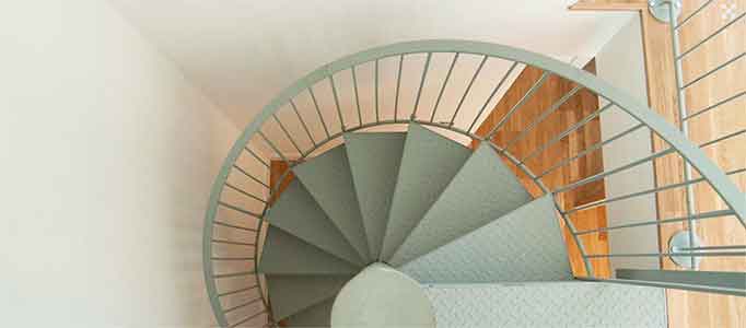 view from above of a light green spiral staircase