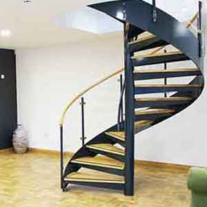 White rear wall, timber floor and black spiral stair