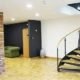 modern spiral stair in an office setting with a wall and a wooden floor on show
