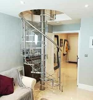transparent spiral stair in a living room setting with sofa