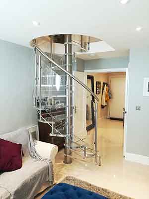 transparent spiral stair in a living room setting with sofa