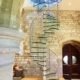 tall glass spiral staircase in a church conversion