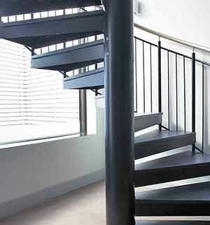 chunky spiral staircase with a large window to rear