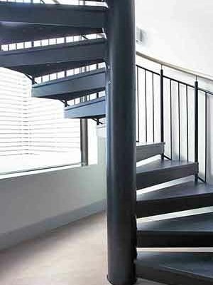 chunky spiral staircase with a large window to rear