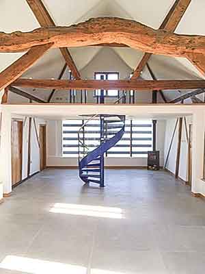 blue steel spiral in a rustic barn conversion - timber beams