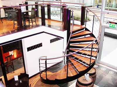 commercial steel and wood spiral stair in a bar setting